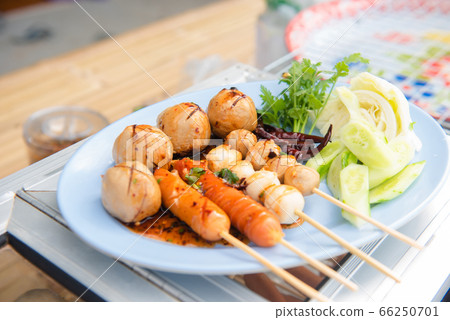 Meatballs toasted on wood dish and a sauce 66250701