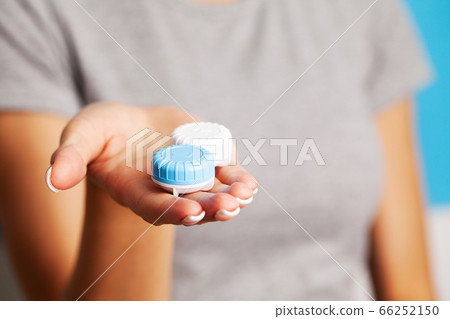 Woman holding a container with contact lenses 66252150