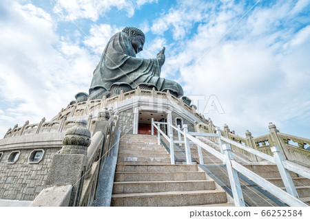 Side View of Tian Tan Giant Buddha in blue sky 66252584