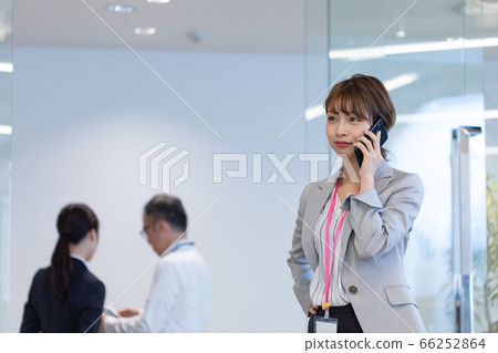 A female employee who contacts with a smartphone during a meeting A female employee who contacts with a smartphone during a meeting 66252864