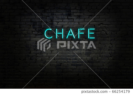 Night view of neon sign on brick wall 66254179