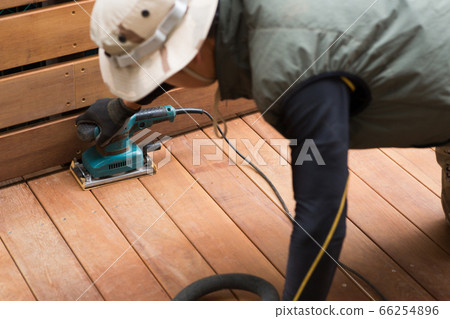 Craftsman making a wood deck 66254896