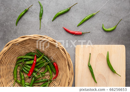 Pepper of thailand in the wooden basket and on the wooden cutting board Pepper of thailand in the wooden basket and on the wooden cutting board 66256653