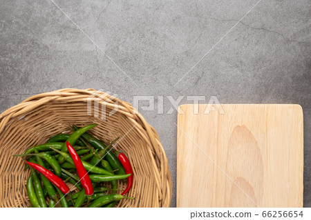 Pepper of thailand in the wooden basket and the wooden cutting board Pepper of thailand in the wooden basket and the wooden cutting board 66256654