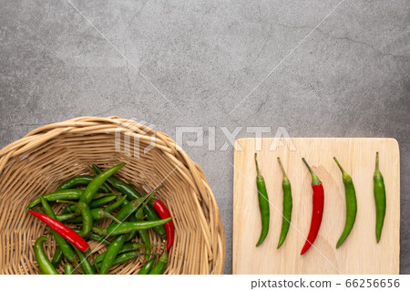 Pepper of thailand in the wooden basket and on the wooden cutting board Pepper of thailand in the wooden basket and on the wooden cutting board 66256656