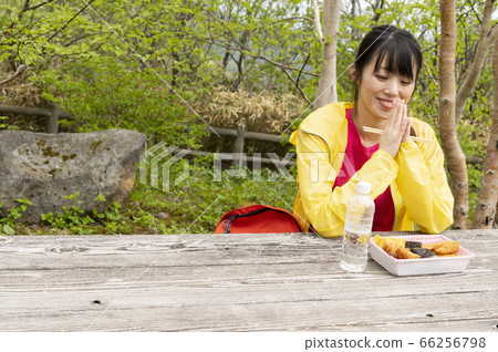 Woman eating bento on a hike Woman eating bento on a hike 66256798