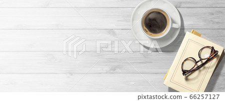Coffee and books on a white wooden table Coffee and books on a white wooden table 66257127