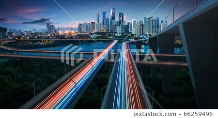 Highway with vehicle light trails leading to 66259496