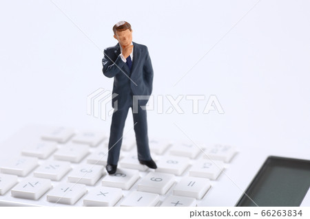 Businessman and calculator Businessman and calculator 66263834