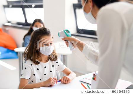 Teacher, child with face mask at school after covid-19 quarantine and lockdown. 66264325