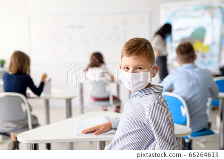 Child with face mask back at school after covid-19 quarantine and lockdown. 66264613