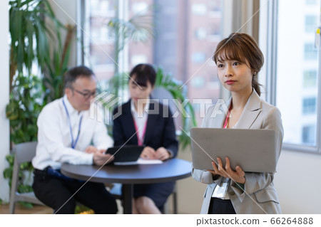 A female employee checking materials during a meeting A female employee checking materials during a meeting 66264888