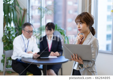 A female employee checking materials during a meeting A female employee checking materials during a meeting 66264895