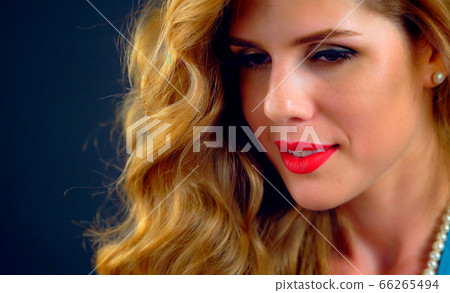 Portrait woman with blonde long curly hair 66265494