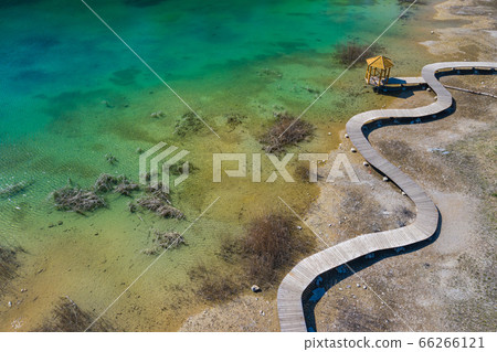 Aerial view of wooden path over turquiose lake Aerial view of wooden path over turquiose lake 66266121