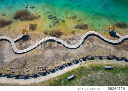 Aerial view of wooden path over turquiose lake Aerial view of wooden path over turquiose lake 66266150
