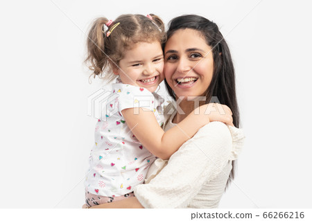 Portrait of happy loving mother and her baby hugging eachother with a smiley face. Portrait of happy loving mother and her baby hugging eachother with a smiley face. 66266216