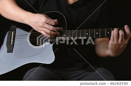Professional musician playing acoustic guitar in music recording studio. Professional musician playing acoustic guitar in music recording studio. 66268590