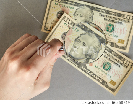 finance. hand with a magnifying glass over paper finance. hand with a magnifying glass over paper 66268749