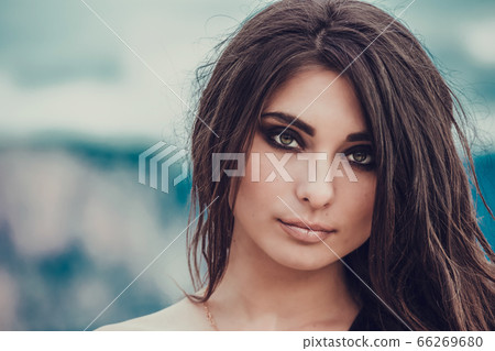 Portrait of beautiful young lady. Outdoors. Smoky 66269680