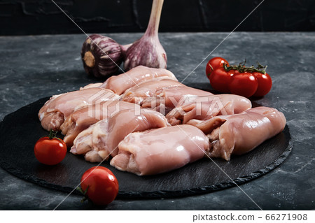 Fresh chicken on a slate tray on the table. Fresh meat concept. Photos for grocery stores Fresh chicken on a slate tray on the table. Fresh meat concept. Photos for grocery stores 66271908