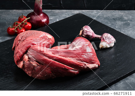 marbled beef fresh tenderloin, freshly meat on a slate plate on a gray background with vegetables. copy space, photo for grocery stores 66271911