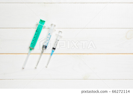 Top view of syringes of different sizes on wooden 66272114
