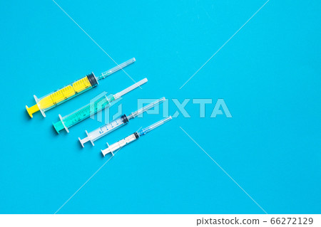 Top view of different syringes at blue background. Top view of different syringes at blue background. 66272129