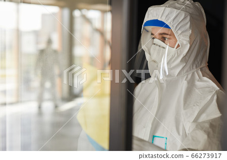 Female Worker doing Chemical Cleaning Indoors 66273917