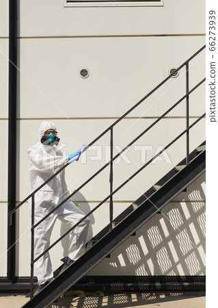 Disinfection Worker on Stairs Outdoors 66273939