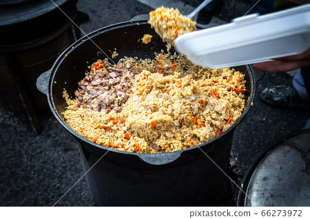 Cooking appetizing traditional oriental pilaf with 66273972