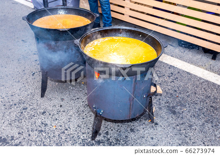 Cooking appetizing traditional food in a large 66273974