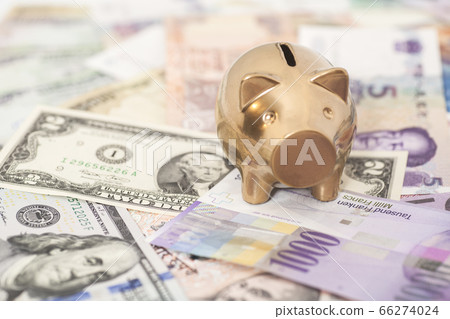 Golden piggy bank with a International currencies 66274024