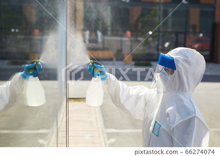 Worker Cleaning Glass Windows Outdoors 66274074