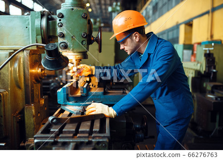 Male technician works on lathe, plant 66276763
