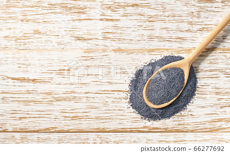 raw seeds of poppy in a wooden spoon on a white raw seeds of poppy in a wooden spoon on a white 66277692