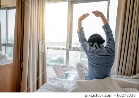 Businessman working with laptop on the bed Businessman working with laptop on the bed 66278336