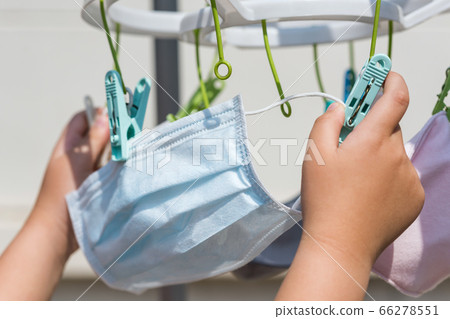 kid hang reuse face mask in sunny day 66278551
