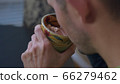 High quality close-up 4k slow motion video of a man drinking hot chocolate beverage 66279462