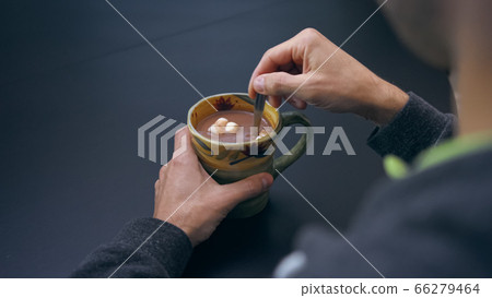 High quality close-up 4k slow motion video of a man mixing hot chocolate beverage High quality close-up 4k slow motion video of a man mixing hot chocolate beverage 66279464
