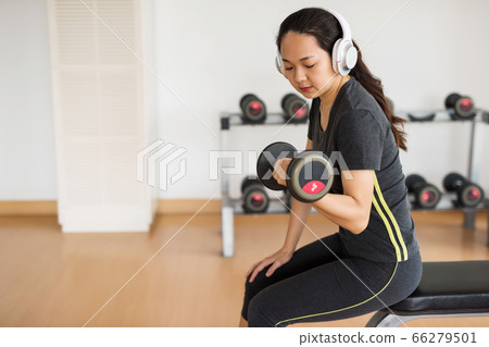 Asian woman workout alone in gym, social Asian woman workout alone in gym, social 66279501
