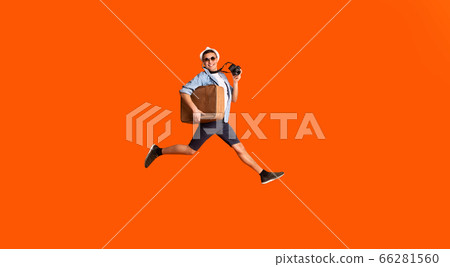 Happy photographer with suitcase running fast over orange background Happy photographer with suitcase running fast over orange background 66281560