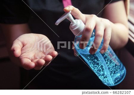 Woman using alcohol gel for cleaning hands Woman using alcohol gel for cleaning hands 66282107