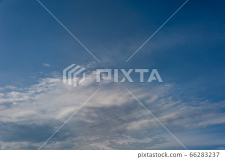 Natural sky composition. Sunny vast blue sky abstract background. Beautiful cloudscape, view over white fluffy clouds. Freedom concept, on the heaven. Element of design. 66283237