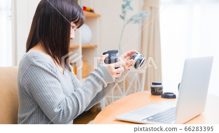 Woman changing camera lens Copy space 16:9 Woman changing camera lens Copy space 16:9 66283395