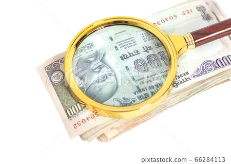 Indian Currency Rupee Notes with magnifying glass 66284113