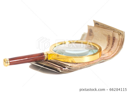 Indian Currency Rupee Notes with magnifying glass Indian Currency Rupee Notes with magnifying glass 66284115