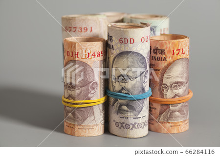 Rolls of Indian rupees isolated on gray background Rolls of Indian rupees isolated on gray background 66284116