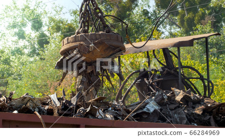 Image of metal scrap and waste stcking to the electric magnet on dump 66284969