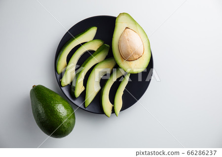 Avocado on a plate and on a white background. Minimum concept Avocado on a plate and on a white background. Minimum concept 66286237